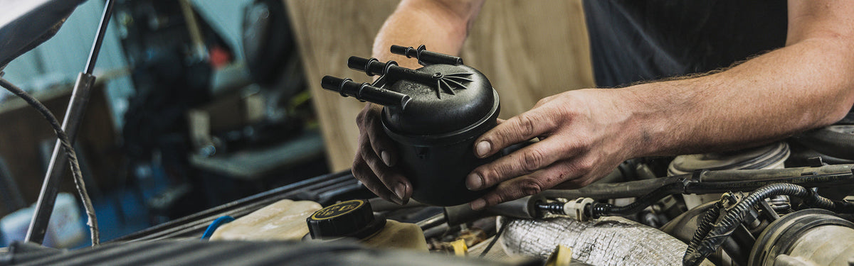 Mechanic Replacing Fuel Filter with Doc's Diesel Fuel Filter