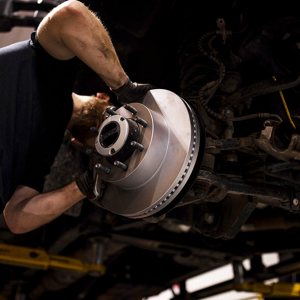 Doc's Diesel High Carbon Brake Rotors being placed on to a car lifestyle