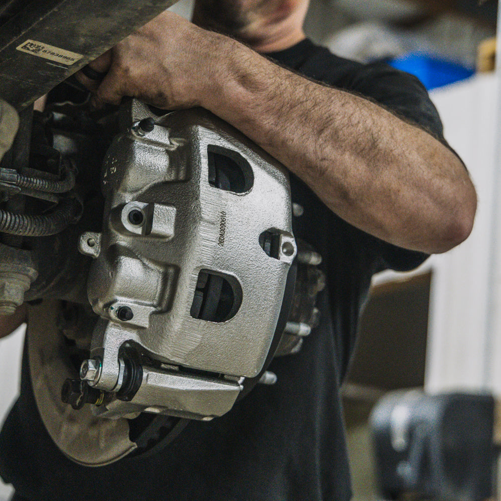 Doc's Diesel calipers, rotors and pads being installed on a diesel truck