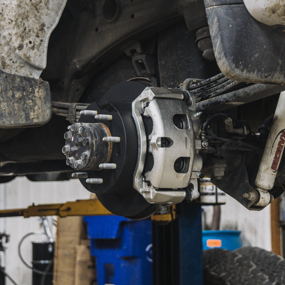 Doc's Diesel calipers, rotors and pads being installed on a diesel truck