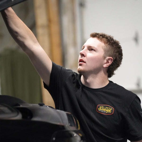 Doc's Diesel Shop T-Shirt Black on a mechanic