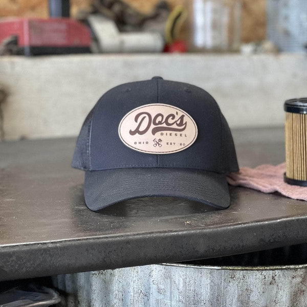 Doc's Diesel Staple Snapback Hat on a work counter